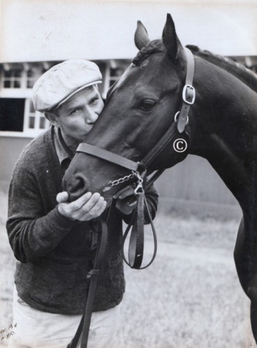 War Admiral gets some love from his groom. 