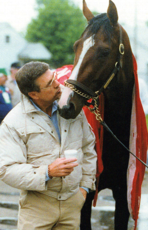 Trainer Carl Nafzger nuzzling 1990 Derby winner Unbridled. 